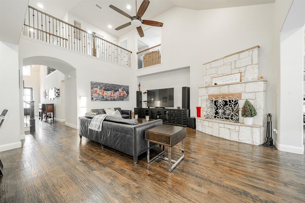 944 Highpoint Way Roanoke, TX 76262 - Photo 8 of 39 a living room with furniture and a flat screen tv