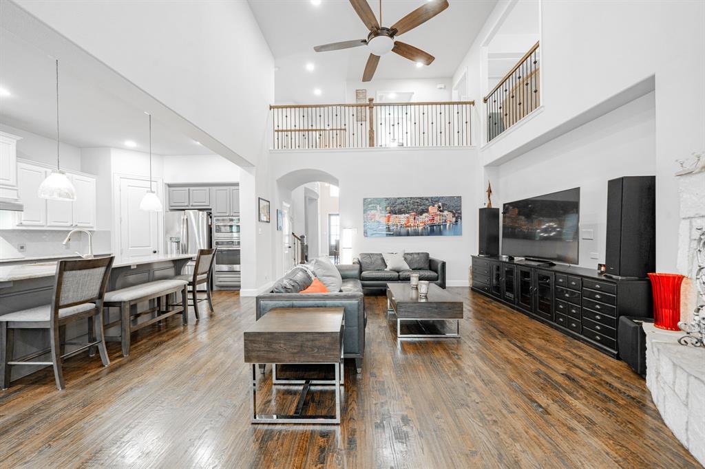 944 Highpoint Way Roanoke, TX 76262 - Photo 9 of 39 a living room with furniture wooden floor and flat screen tv