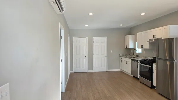 a kitchen with stainless steel appliances a refrigerator and a stove top oven