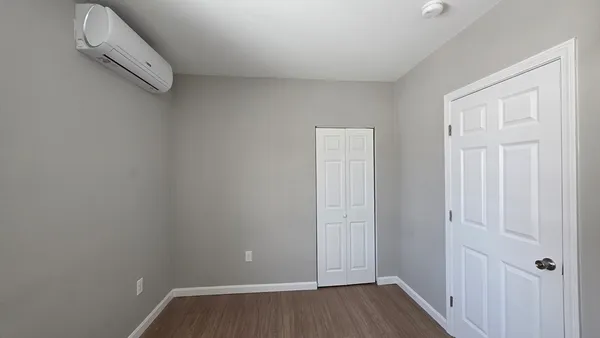 a view of a room with wooden floor