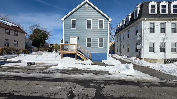 a view of a house with snow on the road