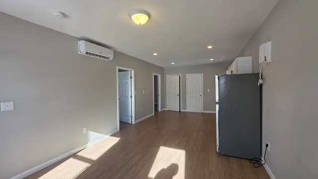 an empty room with wooden floor and closet