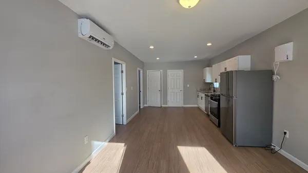 a view of a kitchen with a refrigerator a stove top oven