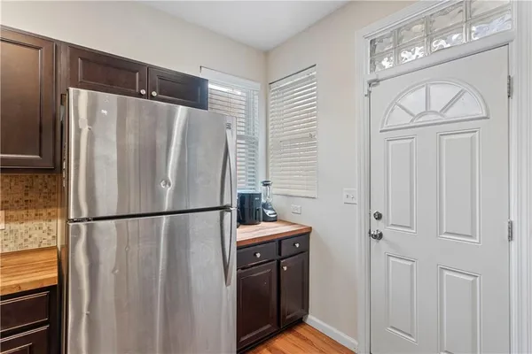 a white refrigerator freezer and a stove sitting inside of a kitchen