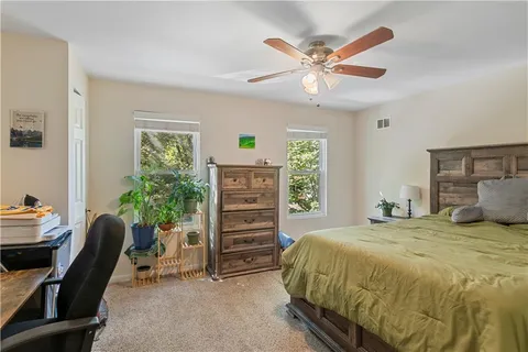 a bedroom with a bed and a bookshelf