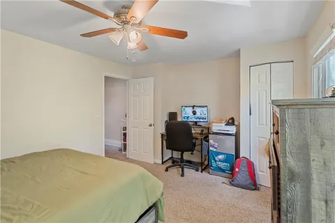 a bedroom that has a bed and a chair in it