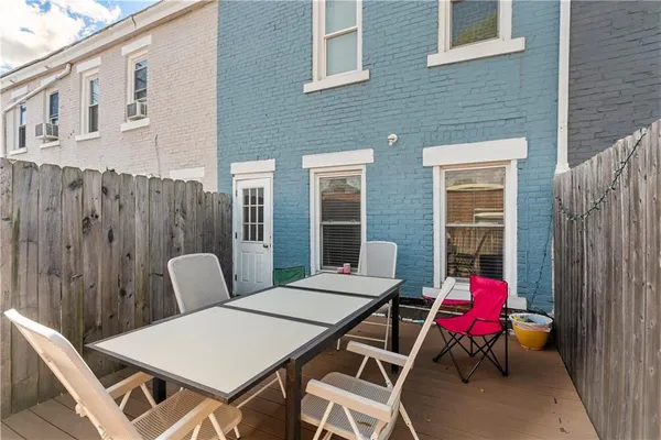 a bedroom with a bed and painting on the wall