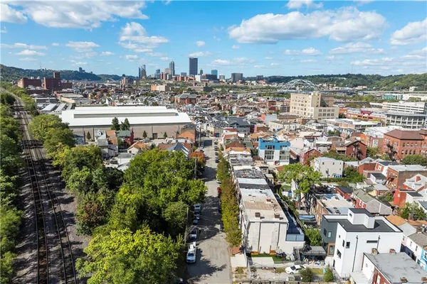 an aerial view of a house with a yard and potted plants