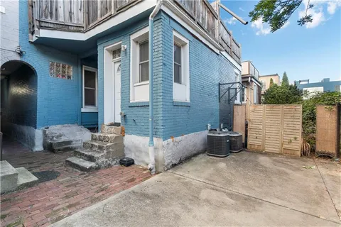 a view of a house with a backyard and a tree