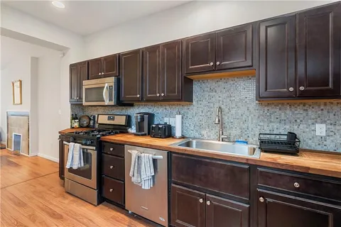 a kitchen with a sink a stove and cabinets