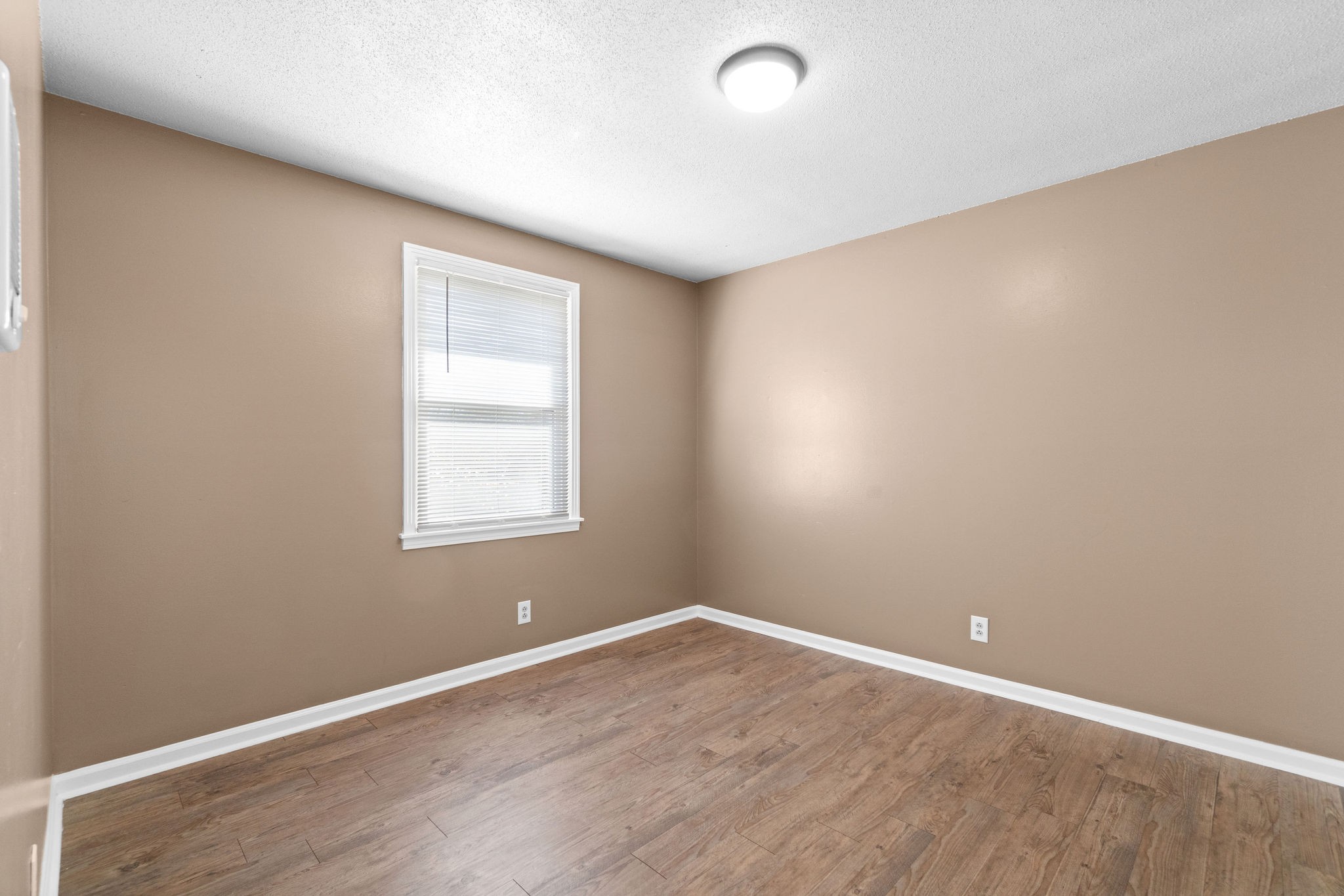 1908 Batts Lane, Unit C Clarksville, TN 37042 - Photo 12 of 14 an empty room with wooden floor and windows
