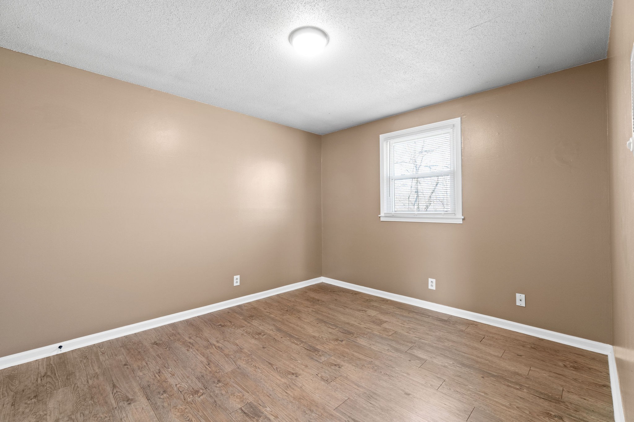 1908 Batts Lane, Unit C Clarksville, TN 37042 - Photo 14 of 14 wooden floor in an empty room with a window
