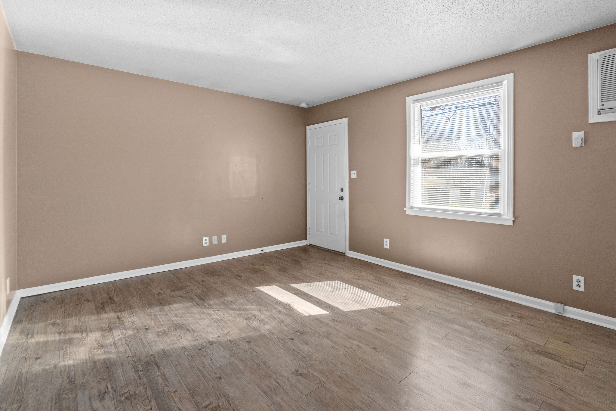 1908 Batts Lane, Unit C Clarksville, TN 37042 - Photo 6 of 14 a view of an empty room with wooden floor and a window