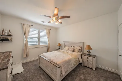 a large bed sitting in a room next to a window