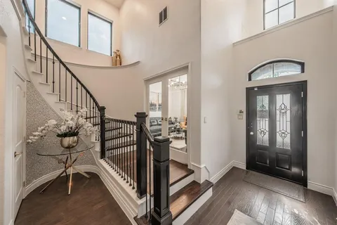 a view of entryway and hall with wooden floor