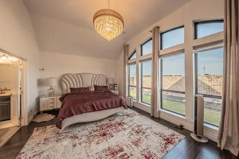 a bedroom with a bed and a large window