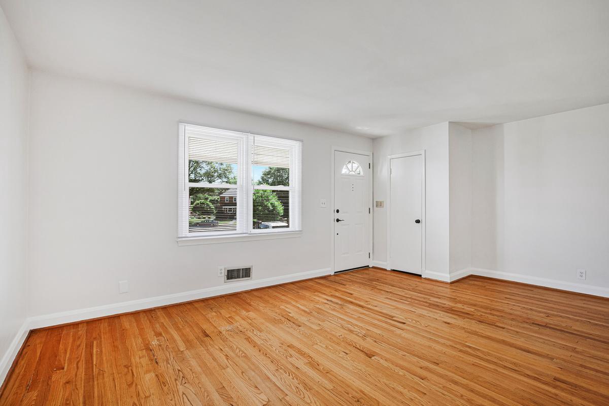 1016 Winsford Road Towson, MD 21204 - Photo 6 of 42 a view of empty room with wooden floor and fan