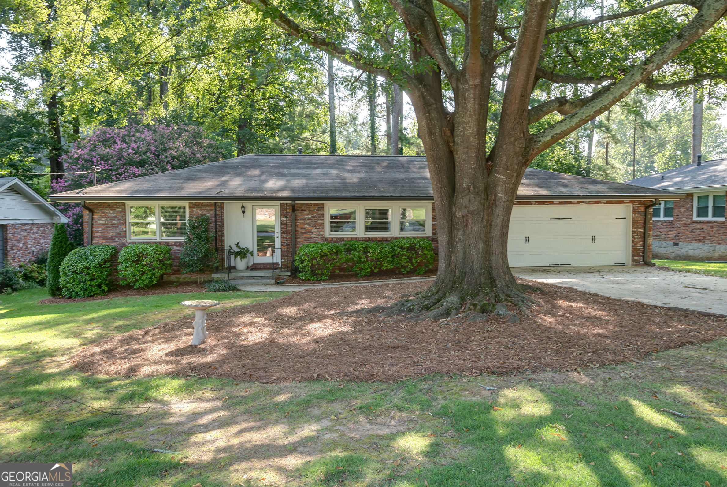 1251 Poinset Place Decatur, GA 30033 - Photo 1 of 1 a front view of a house with a garden