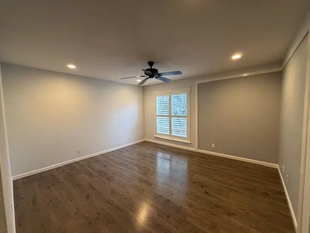 wooden floor in an empty room with a window