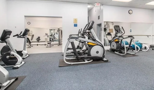 a room with pool table and windows