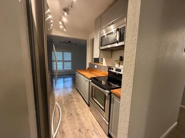 a kitchen with stainless steel appliances granite countertop a stove and a refrigerator