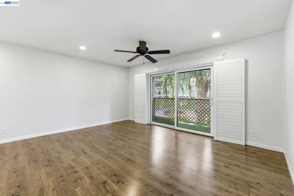 a view of a kitchen with wooden floor and a large window