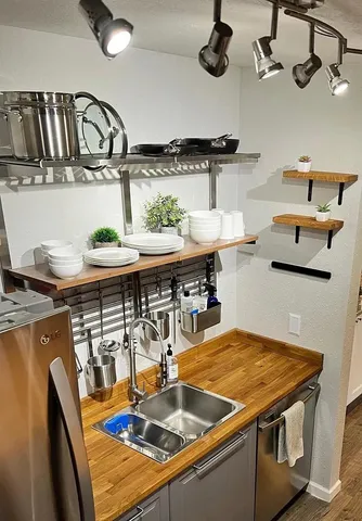 a kitchen with stainless steel appliances granite countertop a sink dishwasher and stove