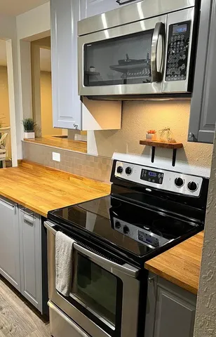 a view of a room with wooden floor and windows