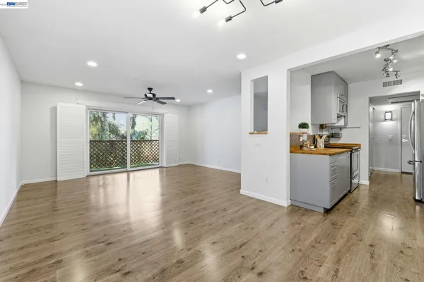 a view of a hallway with wooden floor