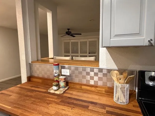 a kitchen with cabinets and a wooden floor