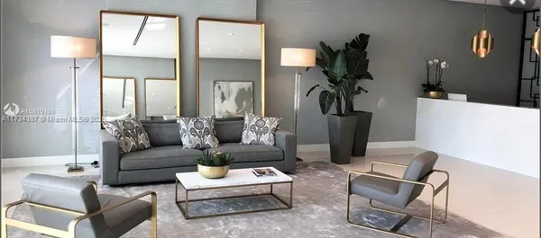 a living room with furniture and a lamp