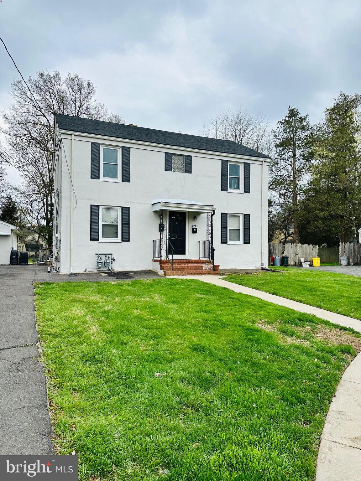1 Marion Court, Unit 2 Ewing, NJ 08618 - Photo 2 of 9 a front view of house with yard and green space