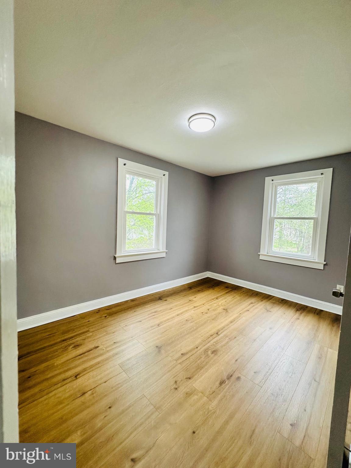 1 Marion Court, Unit 2 Ewing, NJ 08618 - Photo 7 of 9 wooden floor in an empty room with a window