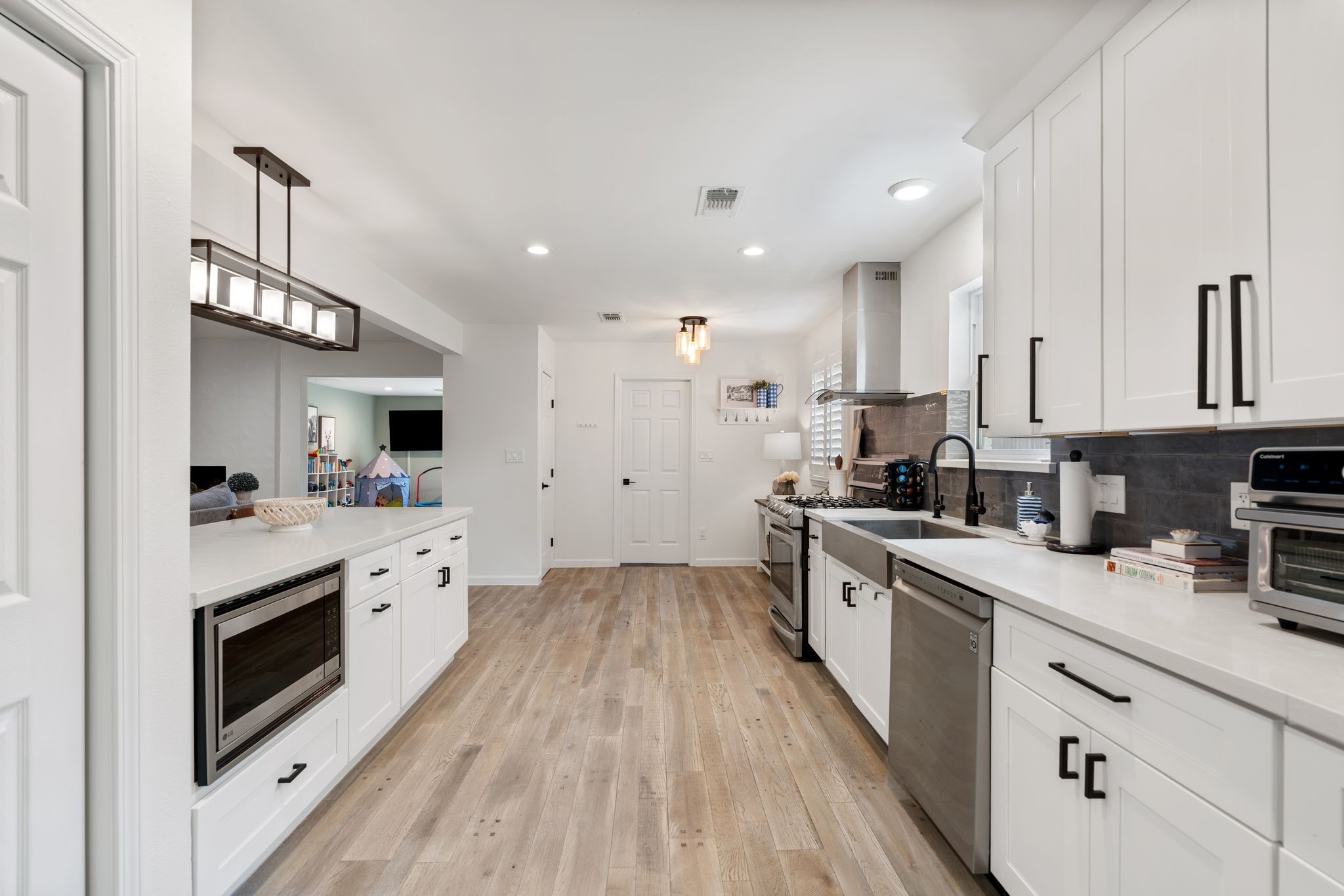10619 Cranbrook Road Houston, TX 77042 - Photo 13 of 32 a large kitchen with stainless steel appliances sink a microwave and cabinets