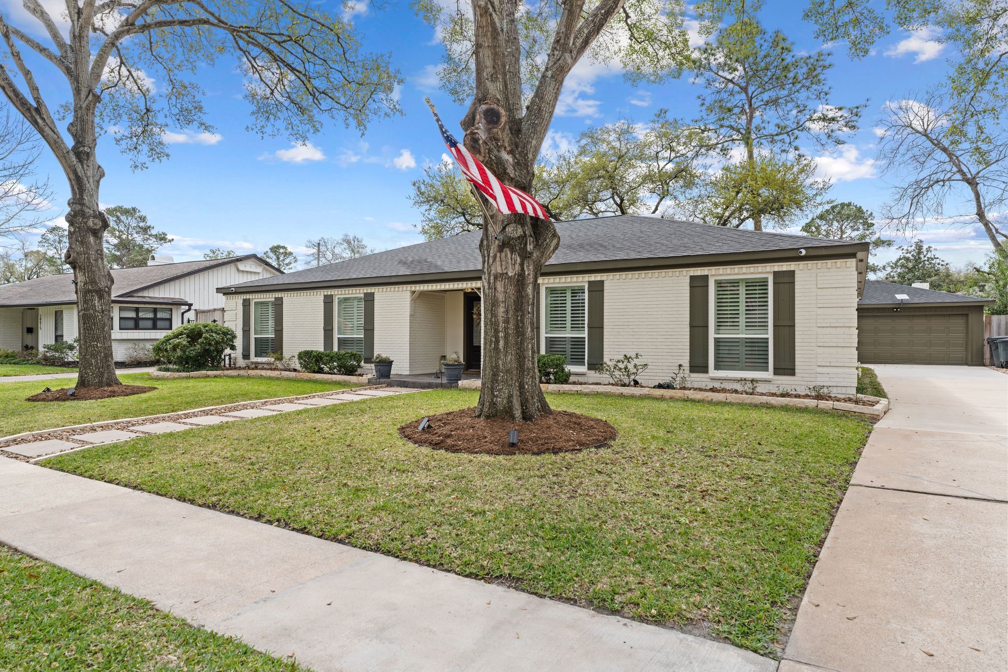 10619 Cranbrook Road Houston, TX 77042 - Photo 2 of 32 a front view of a house with a yard