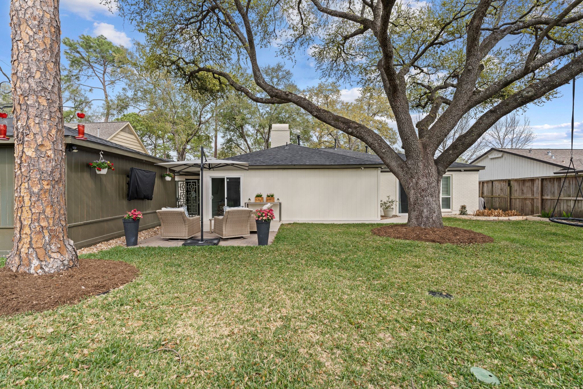 10619 Cranbrook Road Houston, TX 77042 - Photo 30 of 32 a view of a house with backyard and a tree