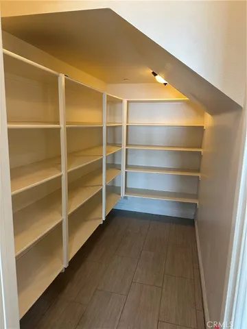 a view of walk in closet with empty racks