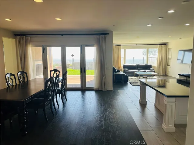 an open kitchen with dining table and stainless steel appliances