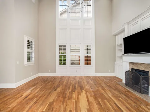 a view of a room with windows and chandelier