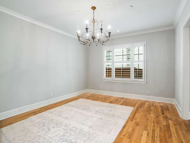 a spacious bathroom with a granite countertop sink a mirror and a shower