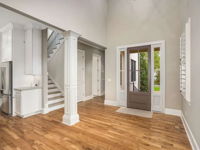 a view of a livingroom with wooden floor and white walls