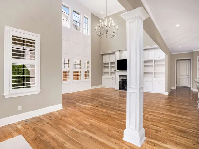a view of an empty room with a fireplace and a window