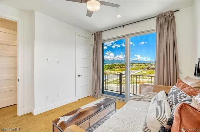 a bedroom with a large bed and a large window