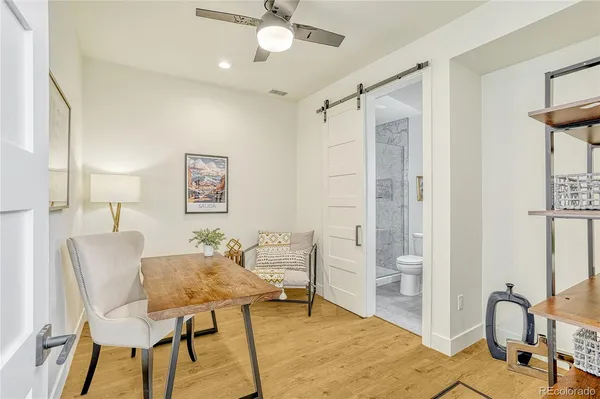 a view of a livingroom with furniture and workspace