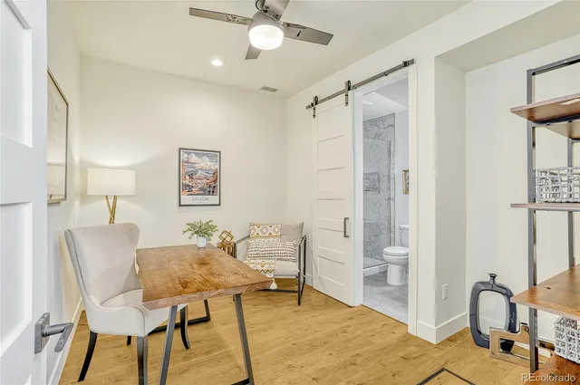 a view of a livingroom with furniture and workspace
