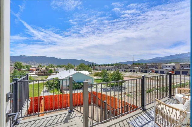 a view of a balcony with wooden floor and fence