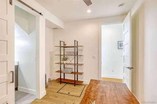 a view of a room with wooden floor and door