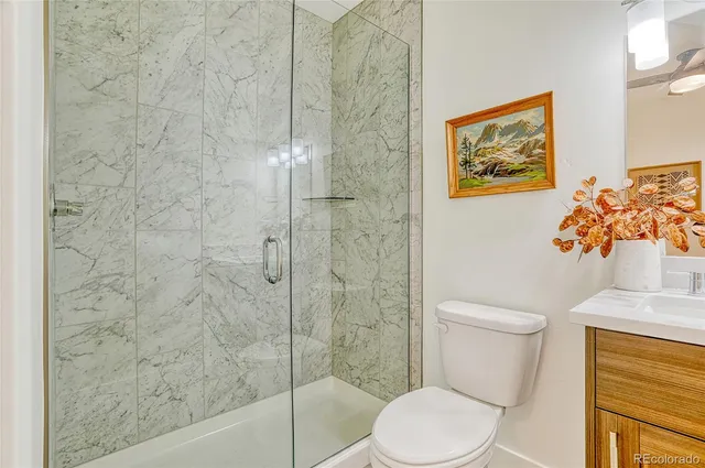 a white toilet sitting next to a bathroom sink