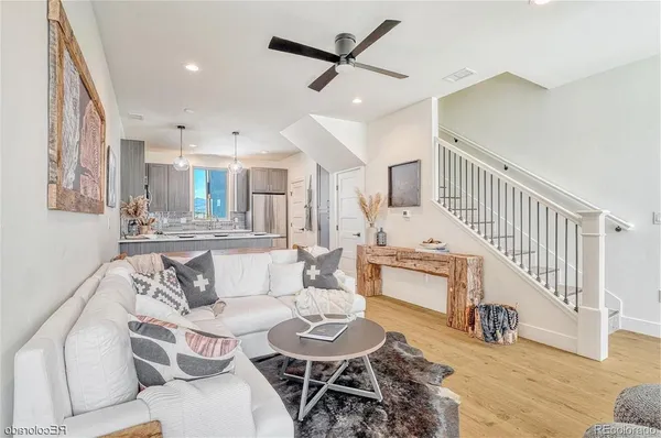 a living room with furniture and a wooden floor