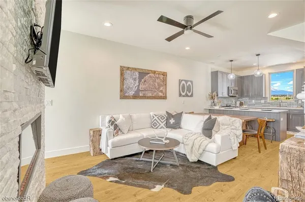 a living room with furniture and kitchen view